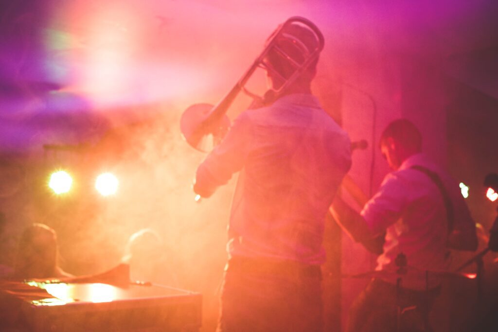 Picture of musicians in stage lighting through mist